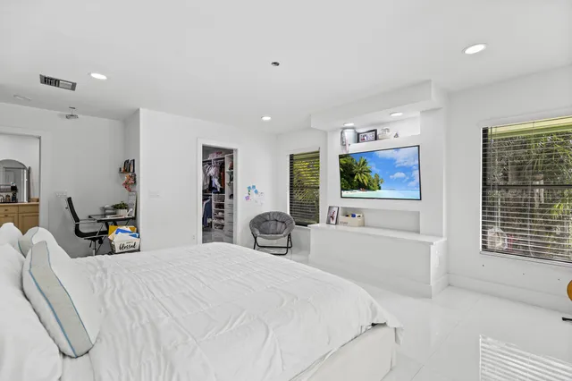 a backyard of a house with barbeque oven table and chairs
