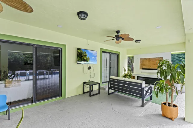 an aerial view of residential houses with outdoor space and trees
