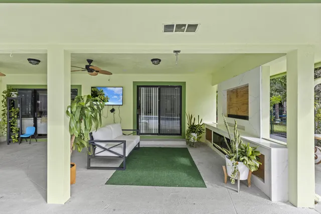 an aerial view of residential houses with outdoor space and trees