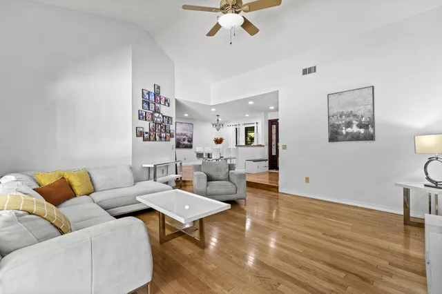 a living room with kitchen island furniture and a chandelier
