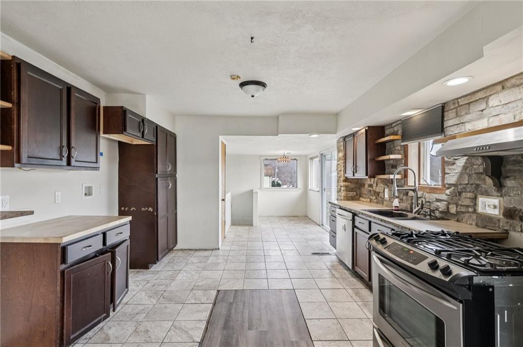 32 Stadium Road Millsboro, PA 15348 - Photo 13 of 47 a large kitchen with stainless steel appliances granite countertop a stove and a sink