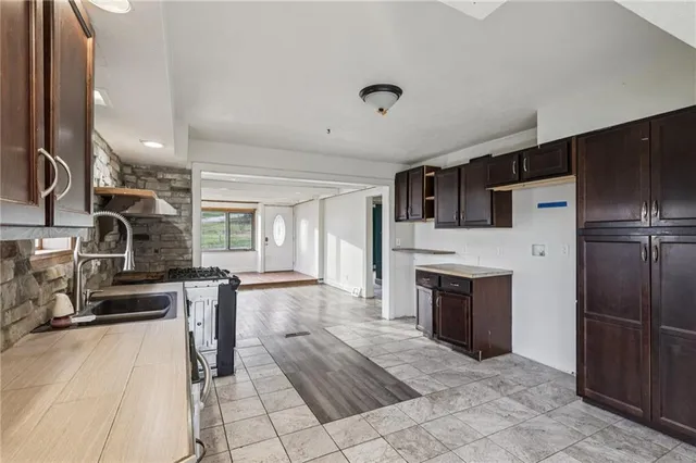 a large kitchen with cabinets and stainless steel appliances