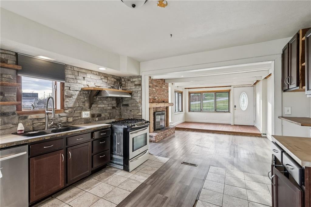 32 Stadium Road Millsboro, PA 15348 - Photo 19 of 47 a large kitchen with stainless steel appliances granite countertop a stove and a sink