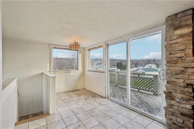 a bathroom with a bathtub and next to a window