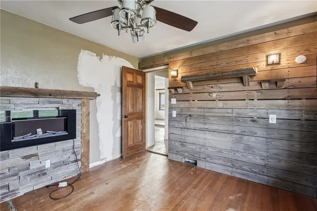 a view of an empty room with a fireplace and a window