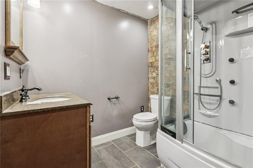 32 Stadium Road Millsboro, PA 15348 - Photo 32 of 47 a bathroom with a granite countertop sink toilet and shower