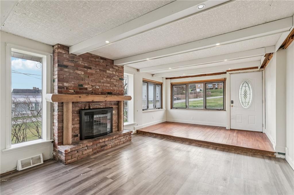 32 Stadium Road Millsboro, PA 15348 - Photo 7 of 47 a view of an empty room with wooden floor and a window
