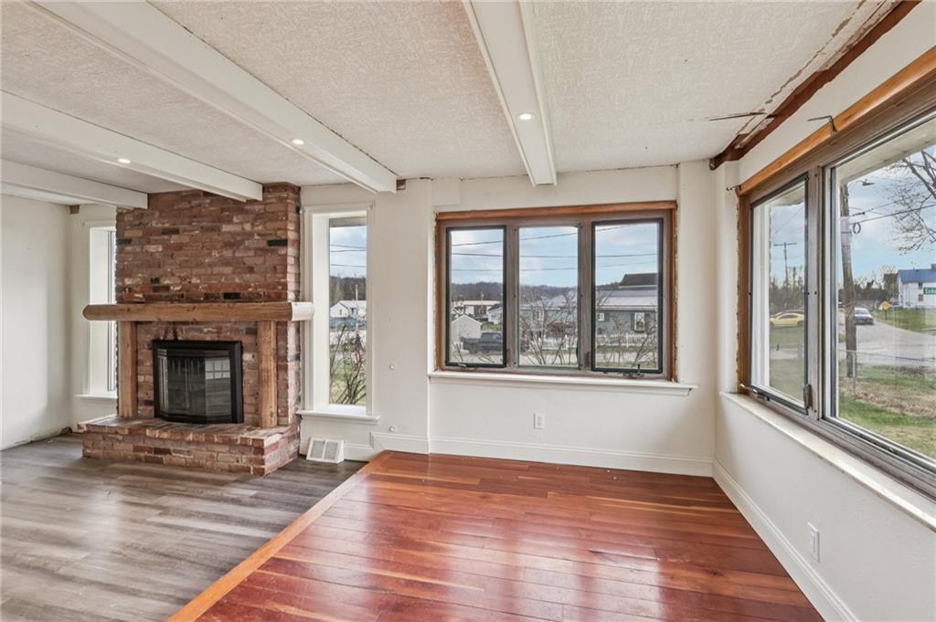 32 Stadium Road Millsboro, PA 15348 - Photo 9 of 47 a view of an empty room with wooden floor and a window