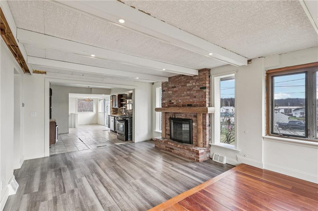 32 Stadium Road Millsboro, PA 15348 - Photo 10 of 47 a living room with furniture and a fireplace