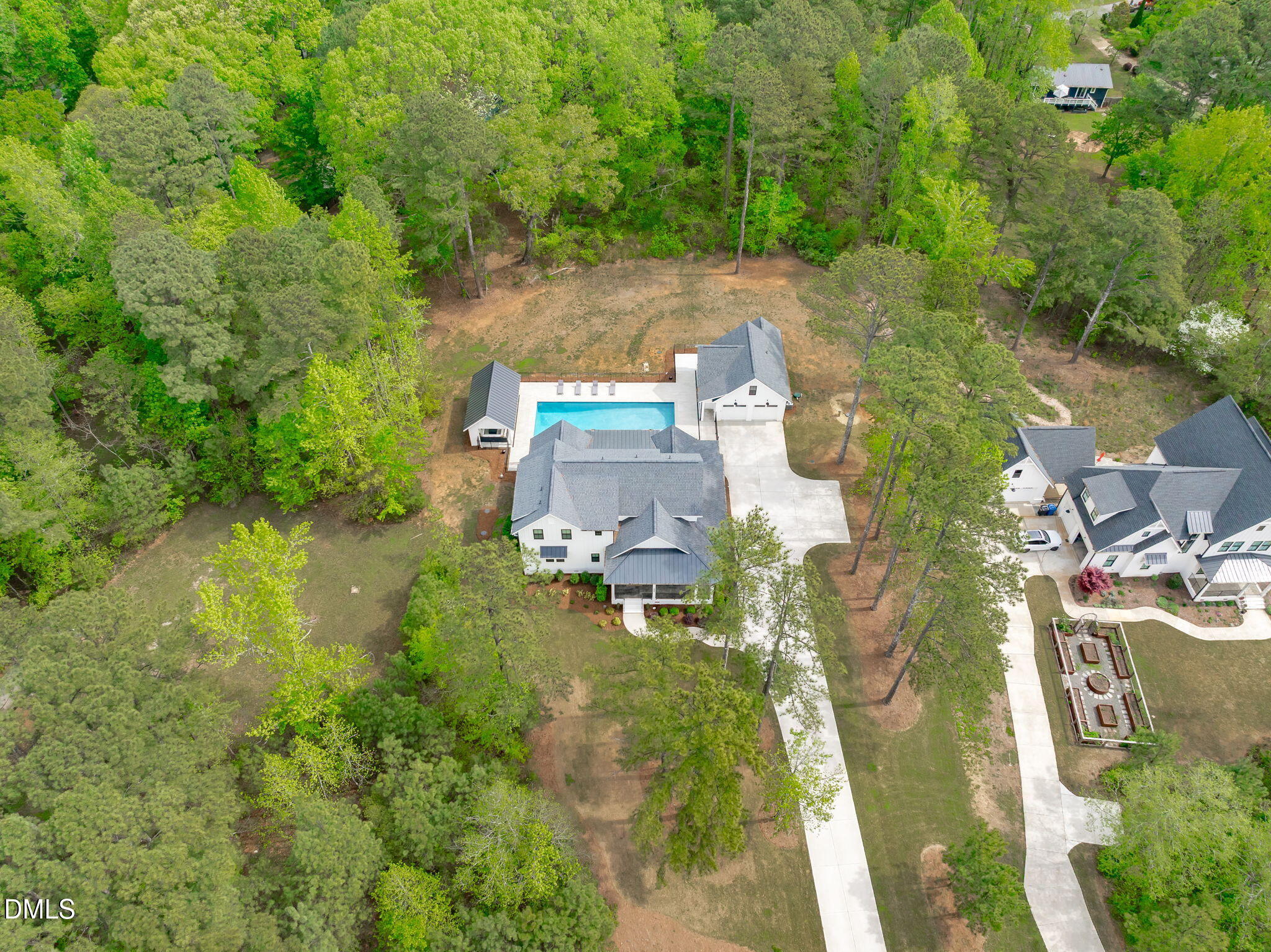 5005 Ten-Ten Road Apex, NC 27539 - Photo 54 of 60 Views of outdoor kitchen, pool, garage, home, and yard.