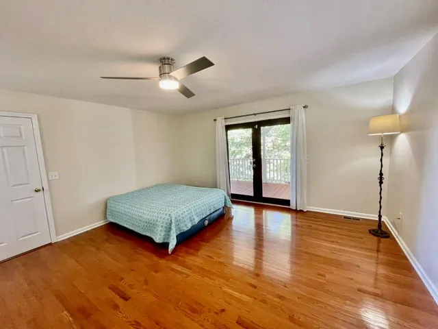 a bathroom with a sink a vanity a mirror a bathtub and next to a window