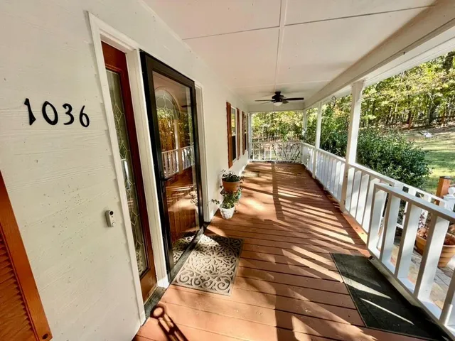 a view of a hallway with wooden floor and cabinet