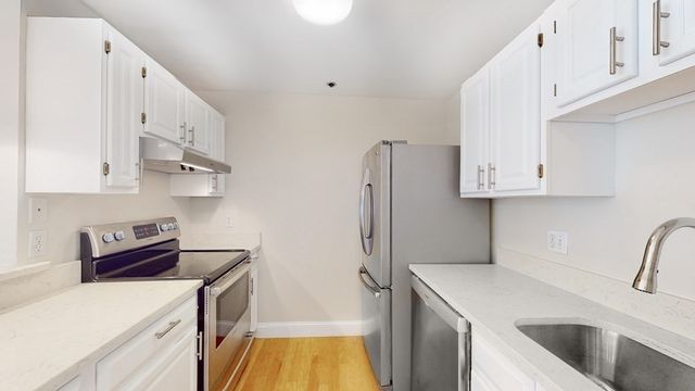 a kitchen with stainless steel appliances a sink a stove and a refrigerator