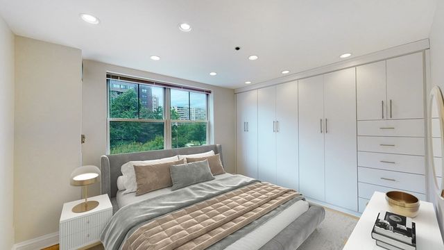 a bedroom with a large bed and a window