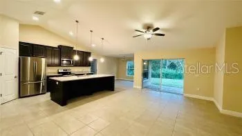 a large kitchen with a cabinets and stainless steel appliances
