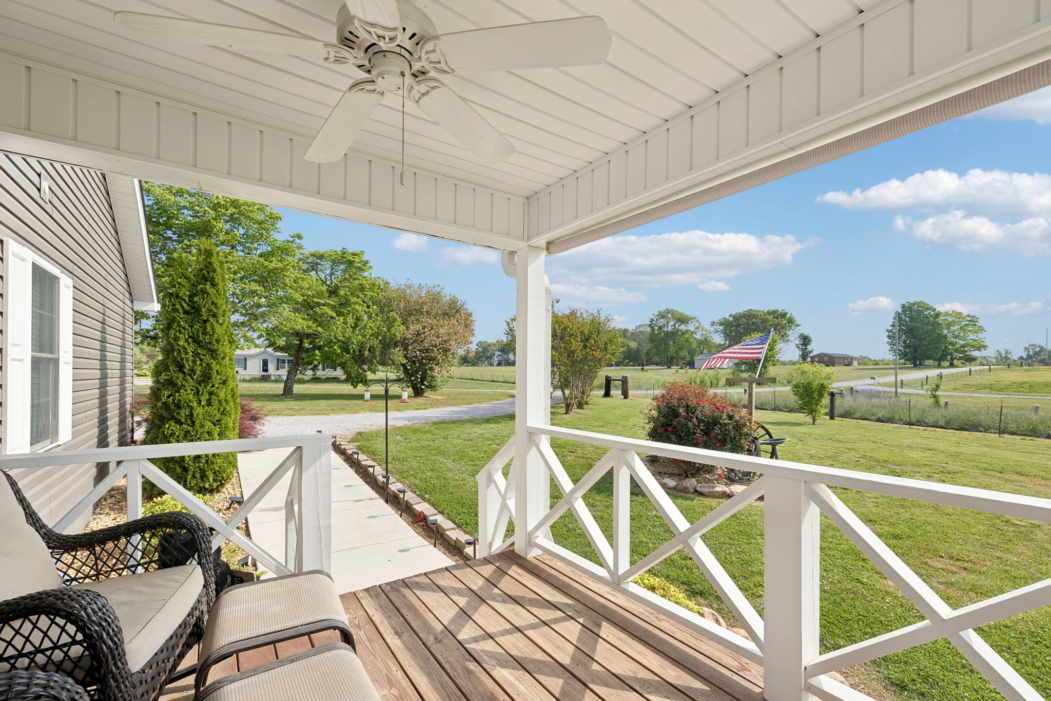 403 Bland Road Estill Springs, TN 37330 - Photo 40 of 66 a view of a patio with a table chairs and a floor to ceiling window