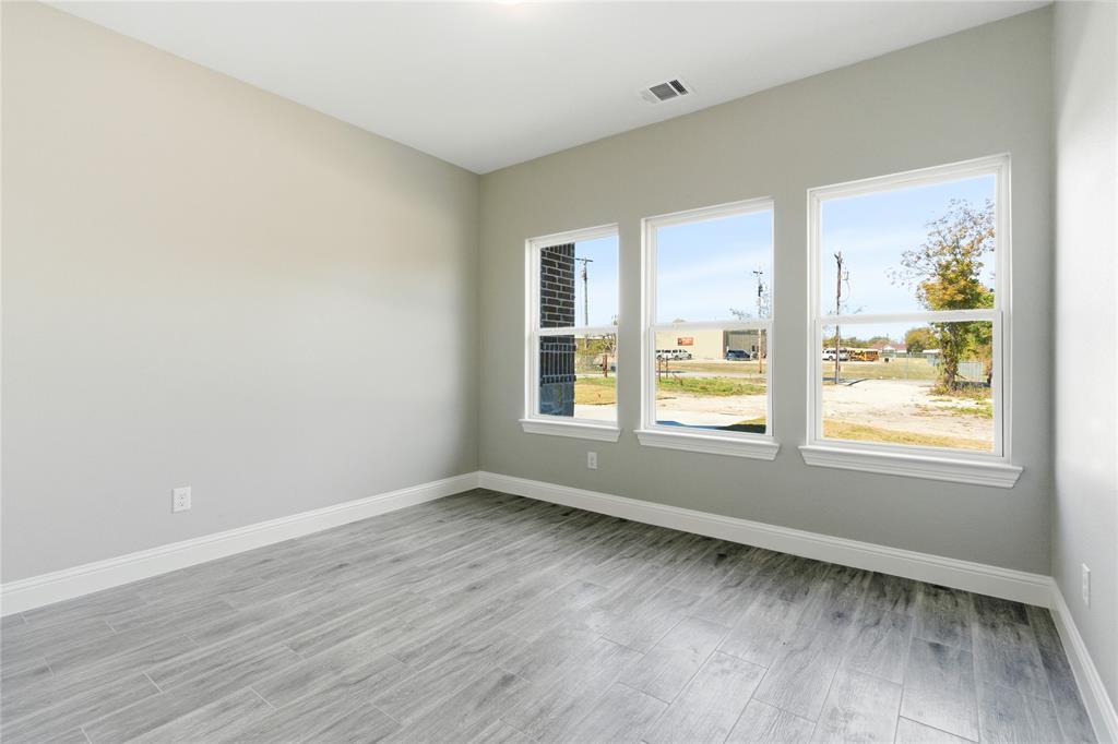 420 Ball Street Tom Bean, TX 75491 - Photo 22 of 34 an empty room with wooden floor and windows