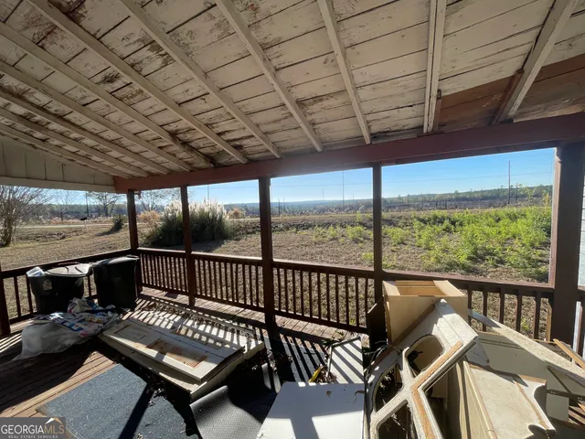 a view of a chairs and table in patio