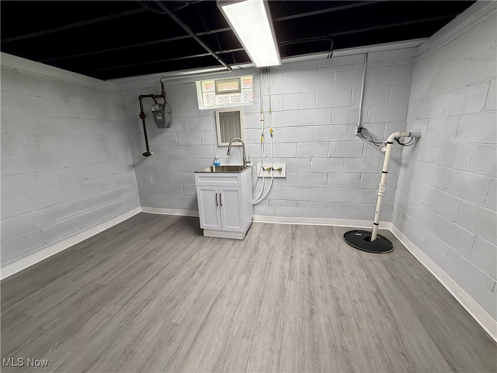 19504 Sumpter Road Cleveland, OH 44128 - Photo 35 of 39 Basement featuring light wood finished floors and drainage system