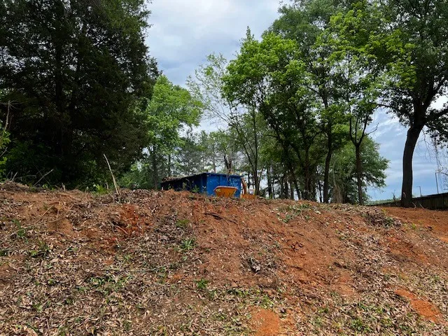 a backyard of a house with large trees
