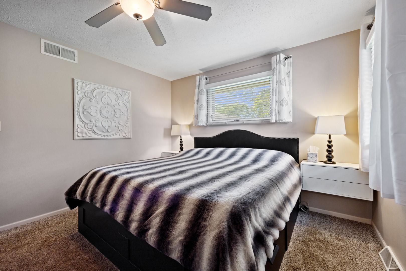 5568 Gray Eagle Road Roscoe, IL 61073 - Photo 16 of 45 a bedroom with a bed and lamp