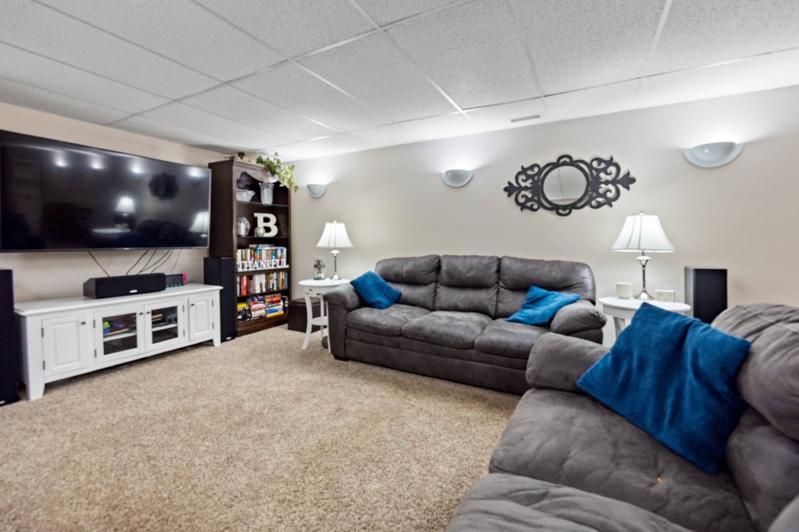 5568 Gray Eagle Road Roscoe, IL 61073 - Photo 25 of 45 a living room with furniture and a flat screen tv