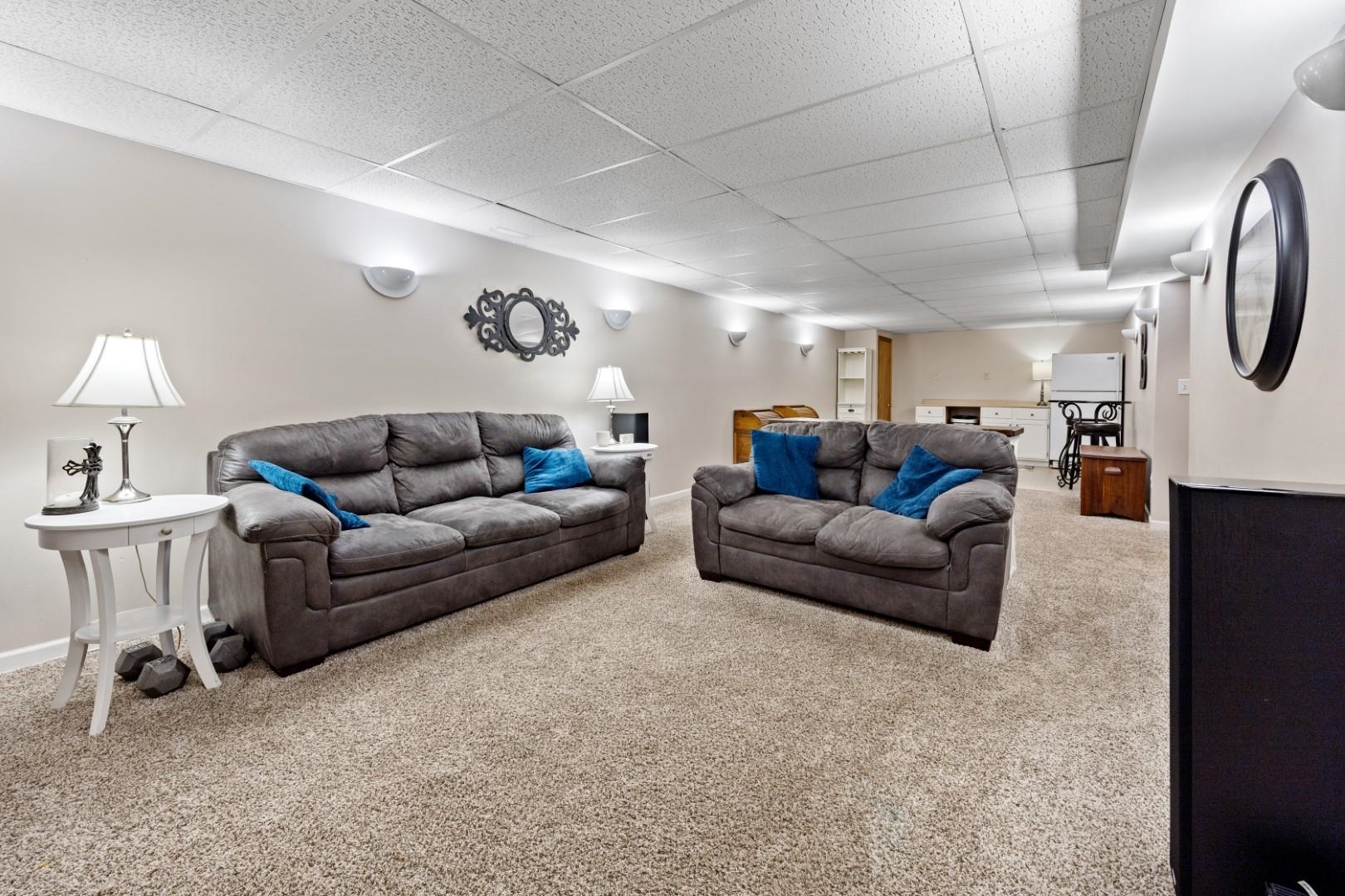 5568 Gray Eagle Road Roscoe, IL 61073 - Photo 28 of 45 a living room with furniture and a chandelier