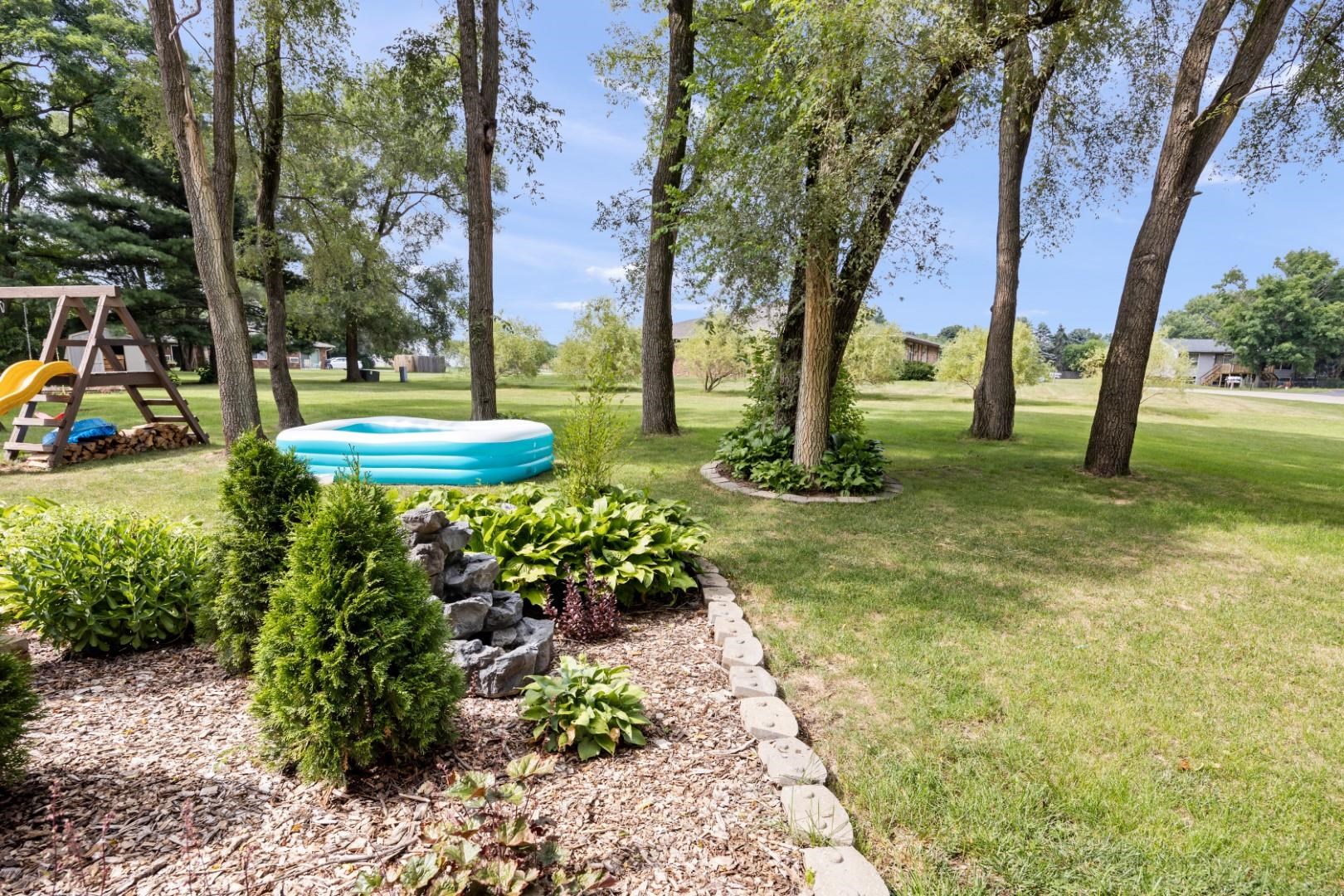 5568 Gray Eagle Road Roscoe, IL 61073 - Photo 40 of 45 a view of a garden with large trees