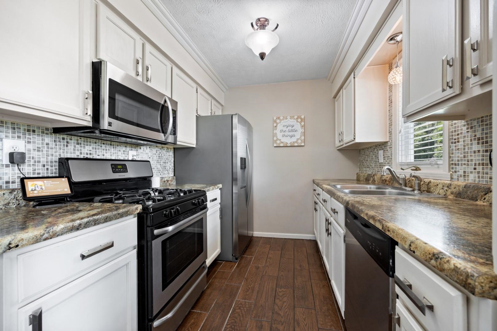 5568 Gray Eagle Road Roscoe, IL 61073 - Photo 4 of 45 a kitchen with stainless steel appliances granite countertop a stove a sink and a microwave