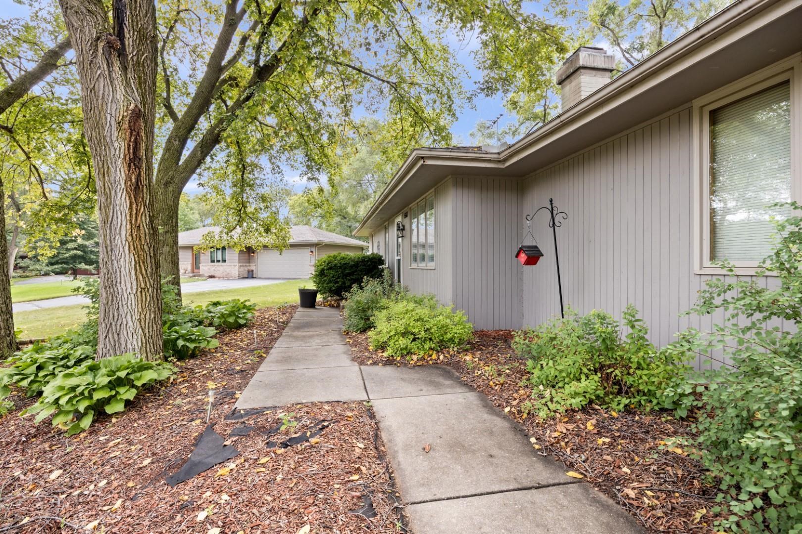 5568 Gray Eagle Road Roscoe, IL 61073 - Photo 44 of 45 a front view of a house with garden