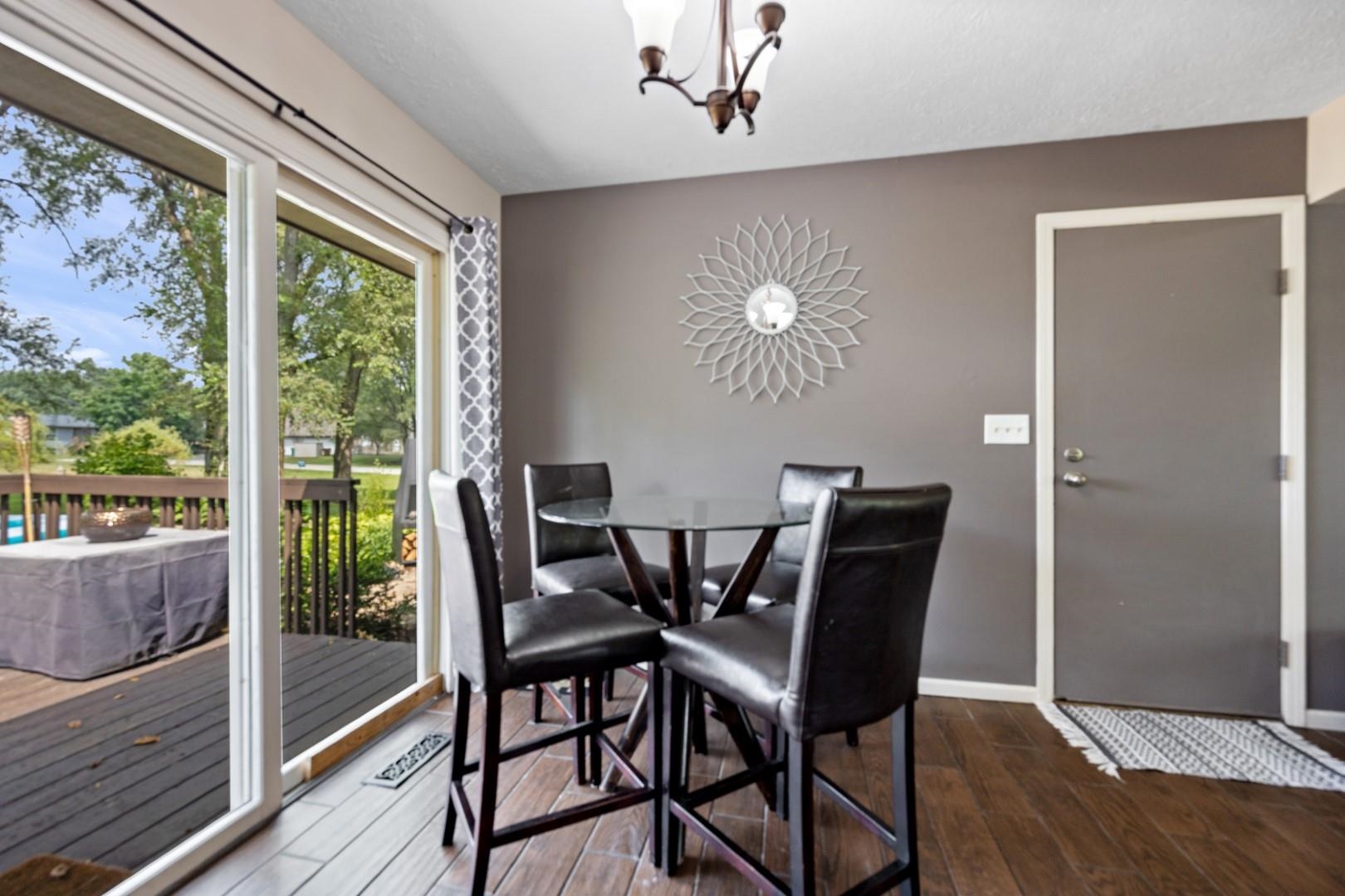 5568 Gray Eagle Road Roscoe, IL 61073 - Photo 8 of 45 a view of a dining room with furniture window and wooden floor