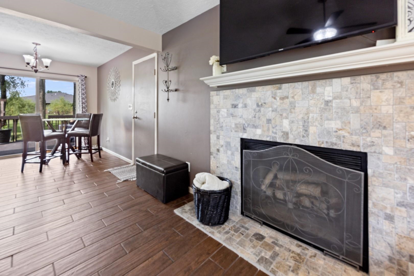 5568 Gray Eagle Road Roscoe, IL 61073 - Photo 9 of 45 a living room with furniture and a fireplace