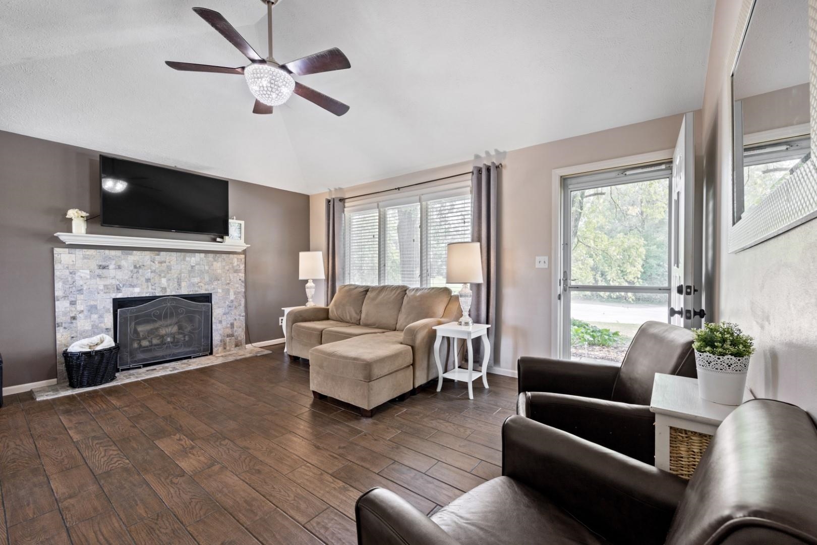 5568 Gray Eagle Road Roscoe, IL 61073 - Photo 10 of 45 a living room with furniture fireplace and flat screen tv