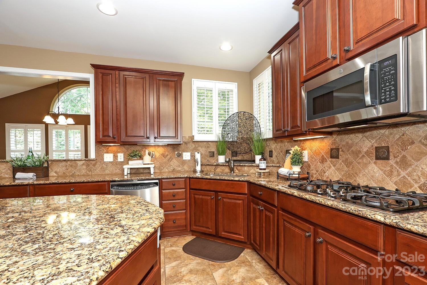 209 Fischer Road Fort Mill, SC 29715 - Photo 11 of 36 a kitchen with wooden cabinets stove top oven and microwave