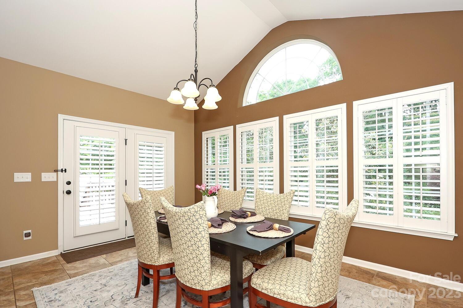 209 Fischer Road Fort Mill, SC 29715 - Photo 14 of 36 a dining room with furniture a chandelier and wooden floor