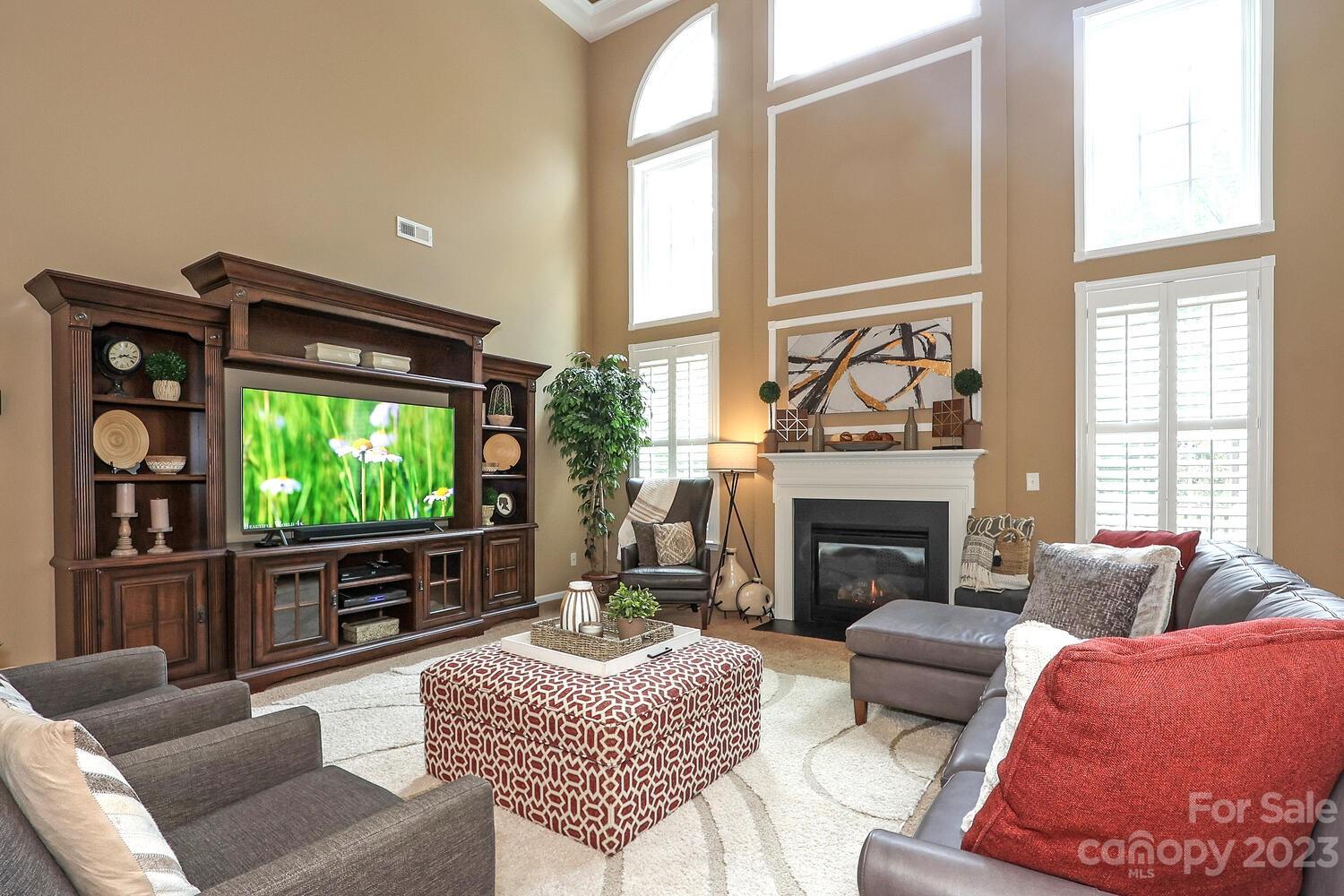 209 Fischer Road Fort Mill, SC 29715 - Photo 16 of 36 a living room with furniture a fireplace and a large window