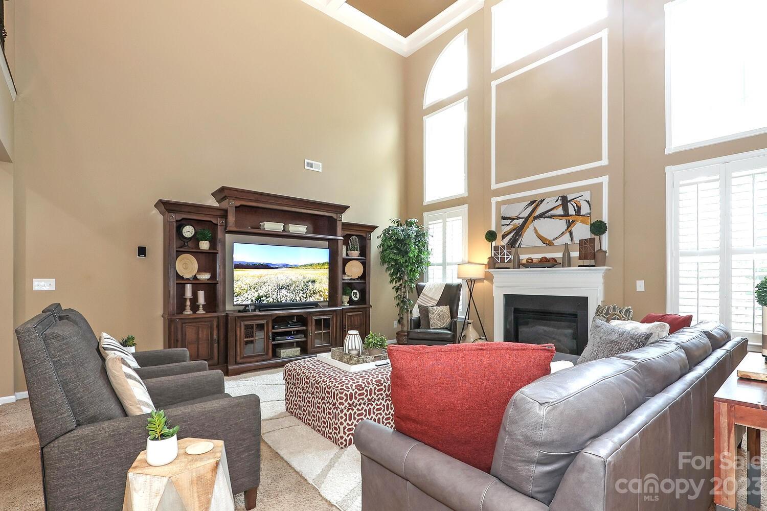 209 Fischer Road Fort Mill, SC 29715 - Photo 17 of 36 a living room with furniture a large window and a fireplace