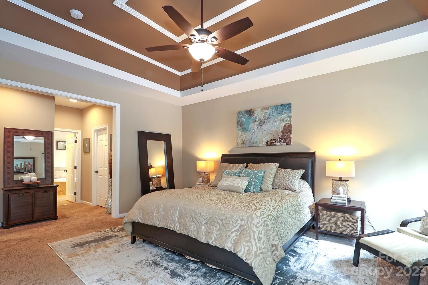209 Fischer Road Fort Mill, SC 29715 - Photo 19 of 36 a bedroom with a bed and a chandelier