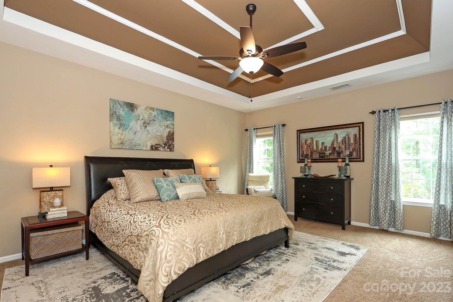 209 Fischer Road Fort Mill, SC 29715 - Photo 21 of 36 a bedroom with a large bed and a chandelier