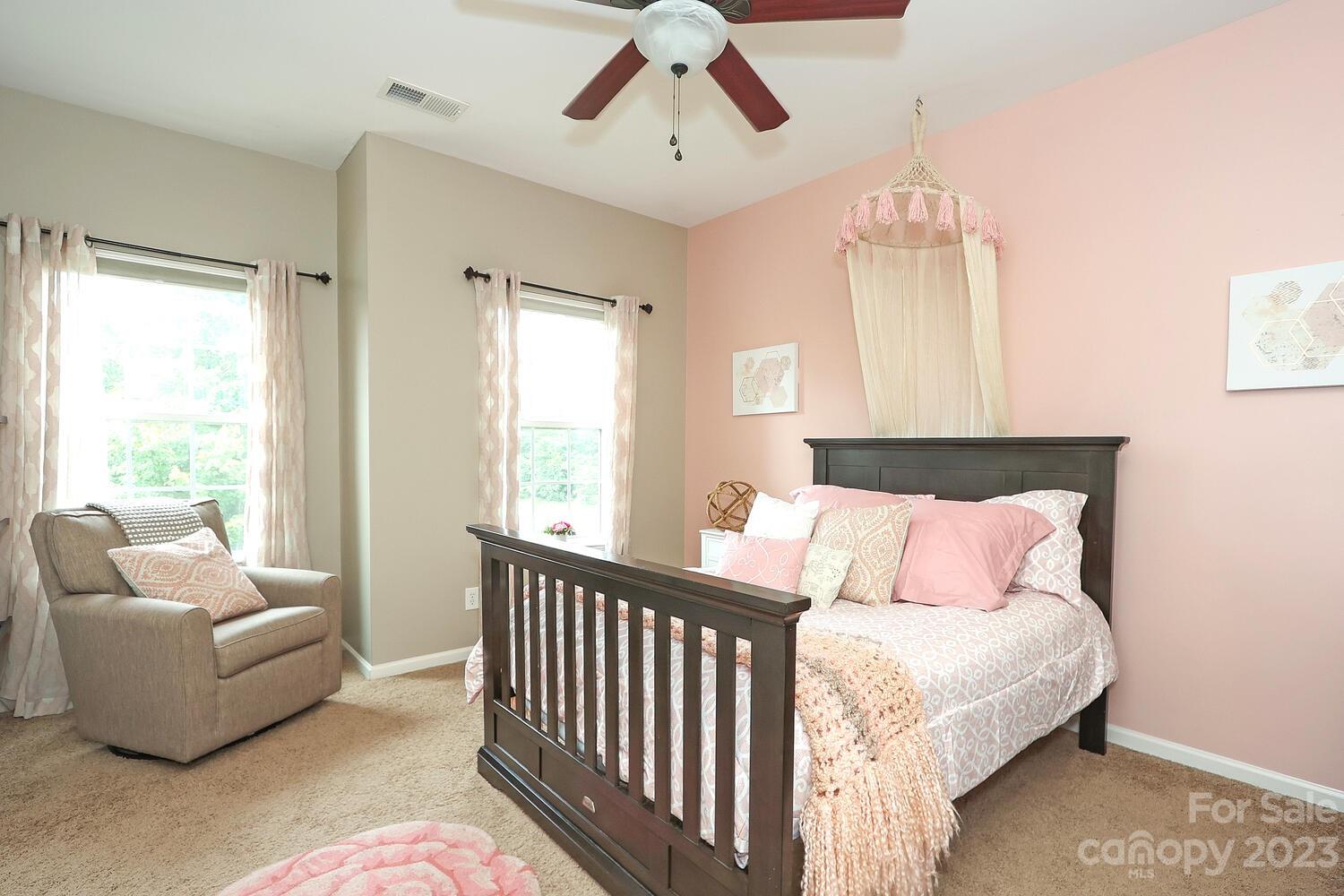 209 Fischer Road Fort Mill, SC 29715 - Photo 26 of 36 a spacious bedroom with a bed and a chandelier