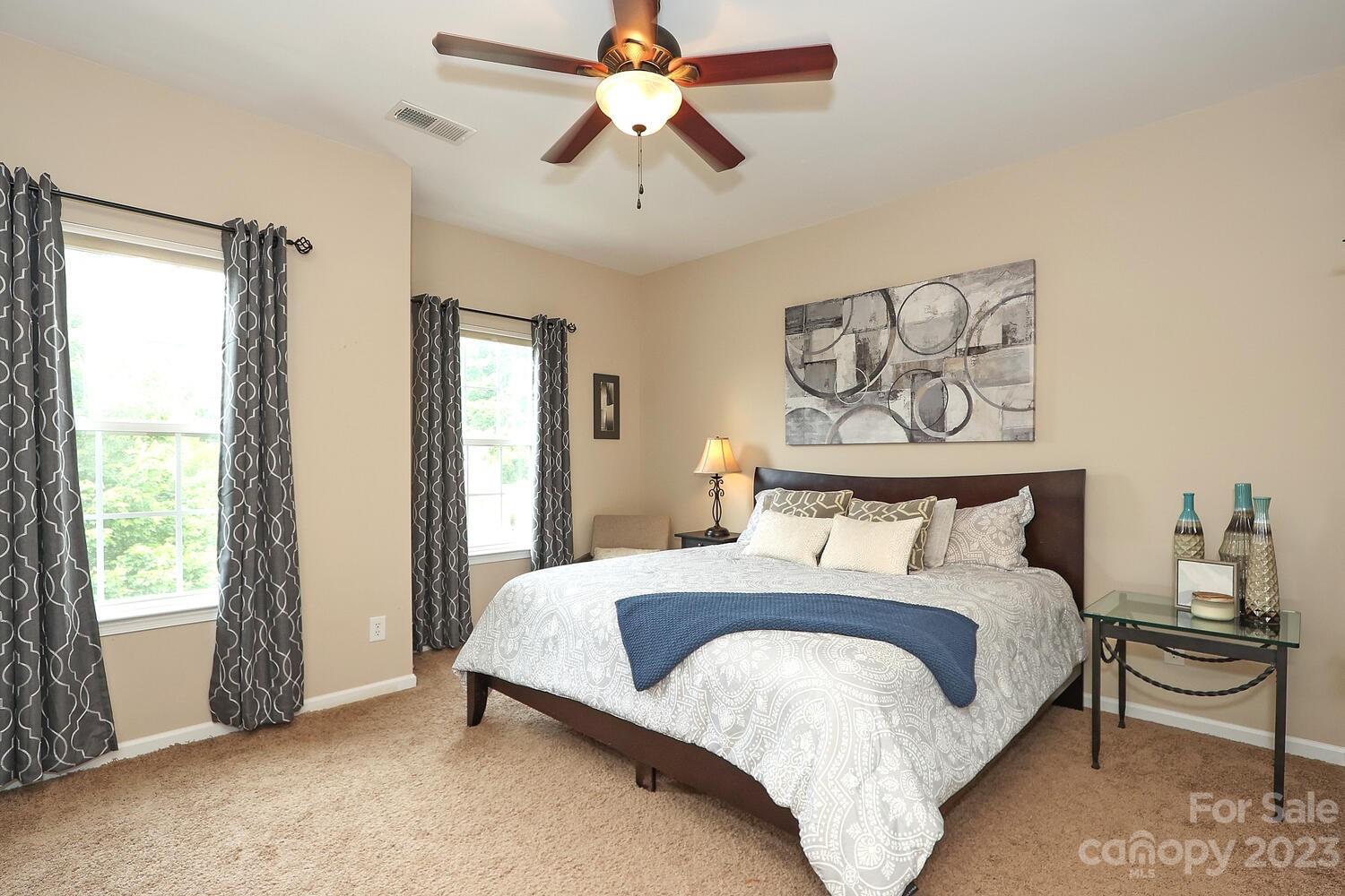209 Fischer Road Fort Mill, SC 29715 - Photo 28 of 36 a bedroom with a bed and a chandelier