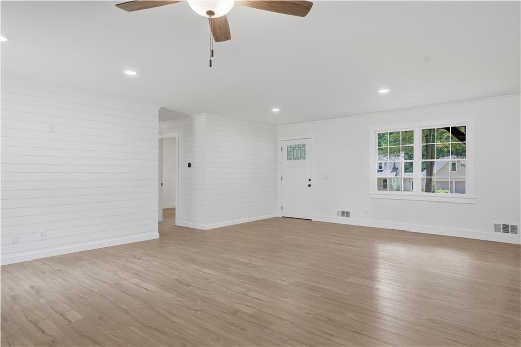 125 Childers Road Canton, GA 30115 - Photo 9 of 48 an empty room with wooden floor cabinet and windows