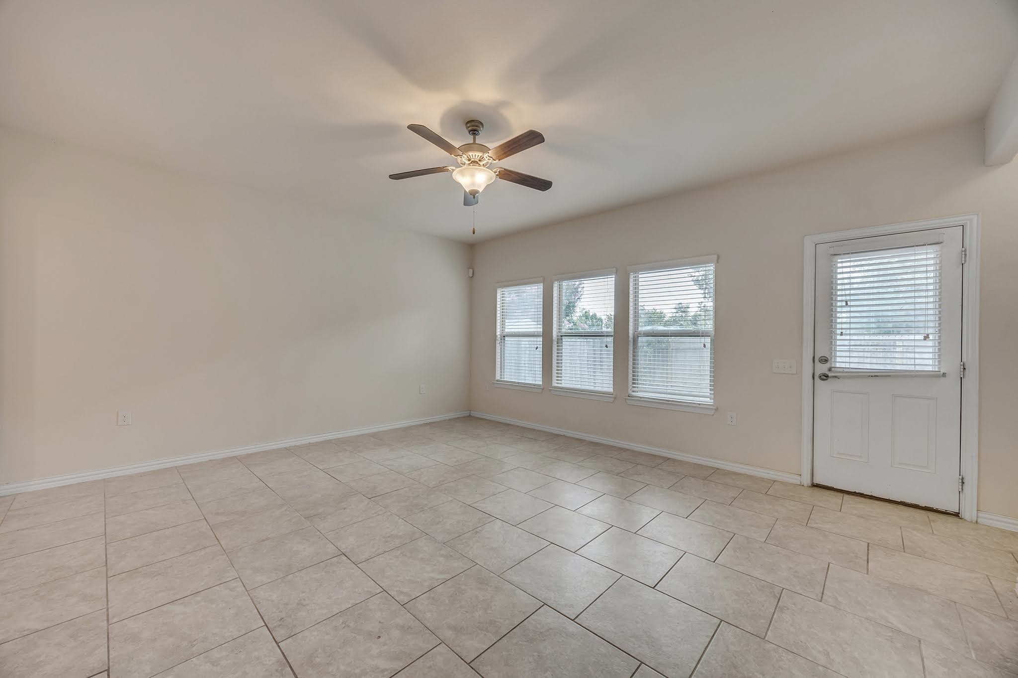 7212 Vail Ridge Street Austin, TX 78744 - Photo 8 of 26 A living space offers generous proportions and a blend of indoor-outdoor accessibility.