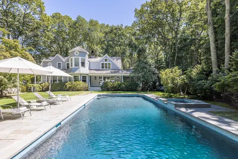 a view of a house with swimming pool and sitting area