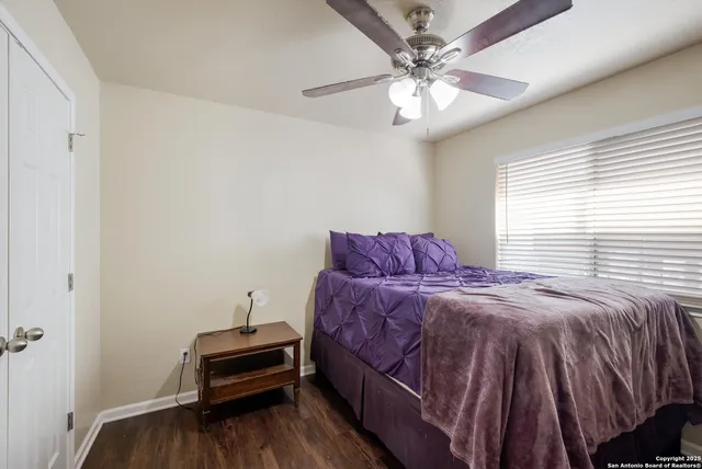 a bedroom with a bed and a ceiling fan