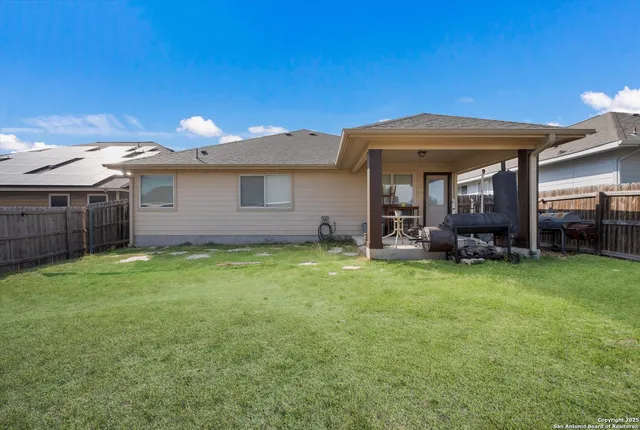 a view of a house with backyard and porch