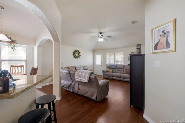 a living room with furniture and a chandelier