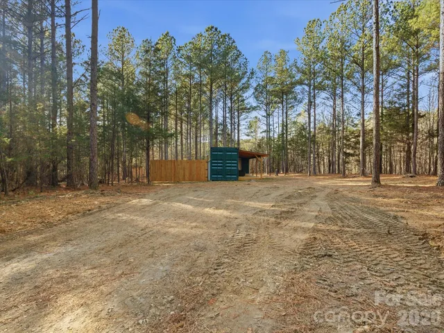 a view of a field with trees in front of it