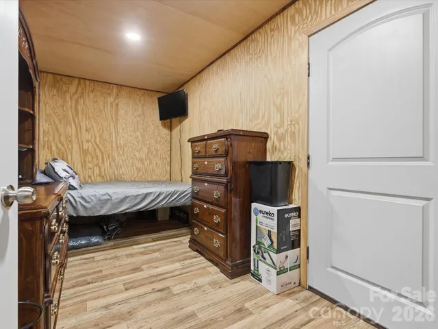a kitchen with stainless steel appliances wooden floor and view living room