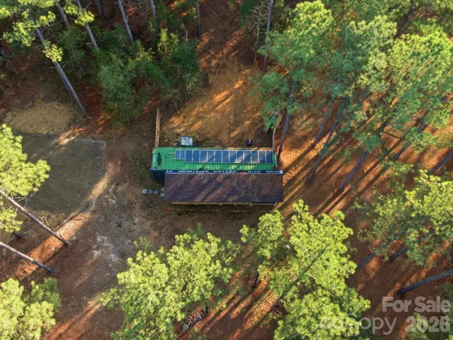 a backyard of a house with a yard and outdoor seating